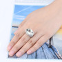 prasiolite and white zircon openwork ring in rhodium over 925 sterling silver worn on a hand