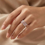 pink and white diamond intertwined band ring worn on hand
