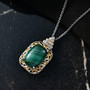 malachite and white zircon pendant necklace in two-tone 18k yellow gold and rhodium over sterling silver shown in a lifestyle photo