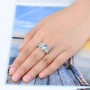 sky blue topaz and white zircon ring in rhodium over 925 sterling silver worn on a hand