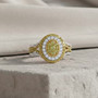 yellow diamond (ir) and white diamond cluster halo ring in rhodium over sterling silver shown in a lifestyle photo