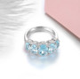 full view of sky blue topaz and white zircon five stone ring in rhodium over 925 sterling silver