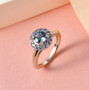 unheated tanzanite and zircon round halo ring in two-tone 18k yellow gold and rhodium over sterling silver shown in a lifestyle photo