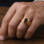 oval garnet and moissanite gents ring in 18k yellow gold over sterling silver worn on a hand