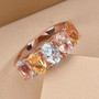 aquamarine and morganite heliodor five stone band ring in 18k rose gold over sterling silver shown in a lifestyle photo