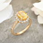 yellow sapphire and diamond halo ring in 14k yellow gold shown in a lifestyle photo