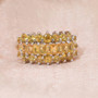 yellow sapphire cluster ring on soft fabric background
