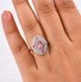 morganite pink sapphire and moissanite ring in 18k rose gold over sterling silver worn on a hand