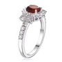angled view of hessonite garnet and white zircon halo ring in rhodium over sterling silver