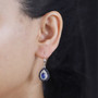 kyanite sapphire and zircon halo earrings in rhodium over sterling silver worn on the ear