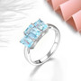 close up of sky blue topaz trilogy ring in rhodium over 925 sterling silver