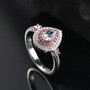aquamarine pink sapphire and moissanite halo ring in 18k rose gold and rhodium over sterling silver shown in a lifestyle photo