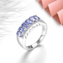close up of tanzanite and white zircon band ring in rhodium over 925 sterling silver