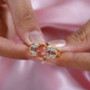 peach moonstone rhodolite and zircon gents ring in 18k yellow gold over sterling silver worn on a hand