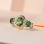 green apatite three stone ring in two-tone 18k yellow gold and rhodium over sterling silver shown in a lifestyle photo