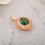 chrome diopside and diamond padparadscha sapphire double halo pendant necklace in 10k yellow gold shown in a lifestyle photo
