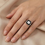 moissanite and black jade halo ring in rhodium over sterling silver worn on a hand