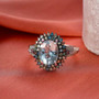 aquamarine and multi-color lab diamond halo ring in rhodium over sterling silver shown in a lifestyle photo