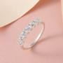 white zircon seven stone band ring in rhodium over sterling silver shown in a lifestyle photo