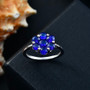 blue spinel flower cluster ring in rhodium over sterling silver shown in a lifestyle photo