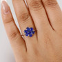 blue spinel flower cluster ring in rhodium over sterling silver worn on a hand