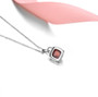 back view of hessonite garnet and white zircon halo necklace in rhodium over sterling silver