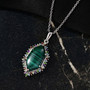 malachite and multi gemstone halo pendant necklace in rhodium over sterling silver shown in a lifestyle photo