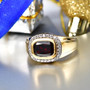 garnet and moissanite halo ring in 18k yellow gold over sterling silver lifestyle display