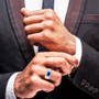blue spinel and moissanite emerald cut halo gents ring in rhodium over sterling silver worn on a hand