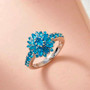 neon blue apatite floral cluster ring in rhodium over sterling silver shown in a lifestyle photo