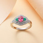 mahenge pink spinel emerald and diamond three stone ring in 950 platinum shown in a lifestyle photo