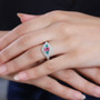 pink spinel emerald and diamond three stone ring in 950 platinum on hand model