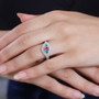mahenge pink spinel emerald and diamond three stone ring in 950 platinum worn on a hand