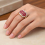 ruby and white zircon cluster ring in 18k yellow gold over sterling silver worn on a hand