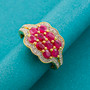 ruby and white zircon cluster ring in 18k yellow gold over sterling silver shown in a lifestyle photo