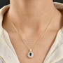 indicolite tourmaline and moissanite pendant necklace in 18k yellow gold over sterling silver worn around the neck