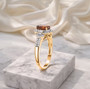 side view of hessonite garnet and moissanite ring in 18k yellow gold over sterling silver