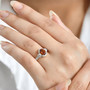 hessonite garnet and moissanite ring in 18k yellow gold over sterling silver worn on a hand