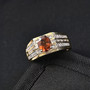 hessonite garnet and moissanite gents ring in 18k yellow gold over sterling silver shown in a lifestyle photo
