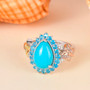 turquoise apatite and multi-color diamond pear halo butterfly ring in tri-tone gold and rhodium over sterling silver shown in a lifestyle photo