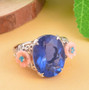 color change fluorite apatite and mother of pearl flower ring in rhodium over sterling silver shown in a lifestyle photo