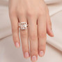 emerald cut morganite and diamond halo ring worn on hand in rose gold