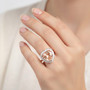 morganite and diamond heart halo ring in 14k rose gold worn on a hand