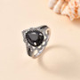 elite shungite pear shaped black spinel and white zircon pear double halo ring in rhodium over sterling silver shown in a lifestyle photo