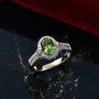 green tourmaline and diamond halo ring in 10k yellow gold shown in a lifestyle photo