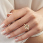 turkizite and diamond pentagon cut halo ring in 14k yellow gold worn on a hand