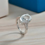 white topaz oval concave cut ring in rhodium over sterling silver shown in a lifestyle photo