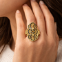 black enamel openwork filigree ring in 18k yellow gold over sterling silver worn on a hand
