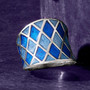 shades of blue enamel harlequin pattern band ring in rhodium over sterling silver shown in a lifestyle photo
