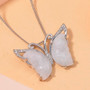 white jade and white zircon carved butterfly pendant necklace in rhodium over sterling silver shown in a lifestyle photo